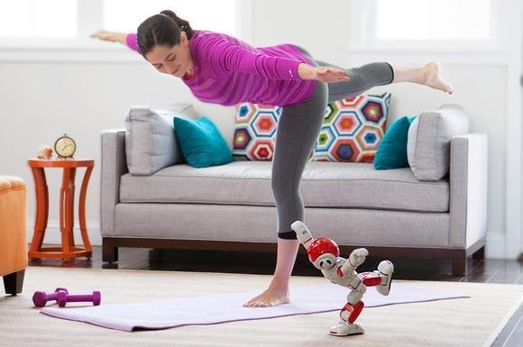 Alpha 2 doing yoga with a woman