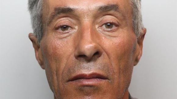 A mugshot of Casimiro De Lemos Francisco. He has short grey hair and looks as if he is smirking.