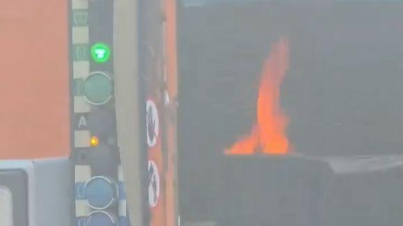 A flame from inside the bin lorry as it catches fire.