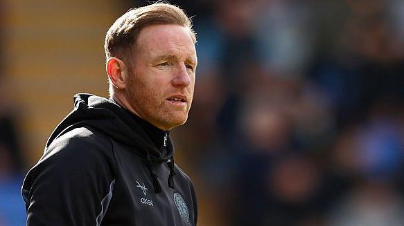 Gavin Cowan looks on from the touchline during a Shrewsbury Town
