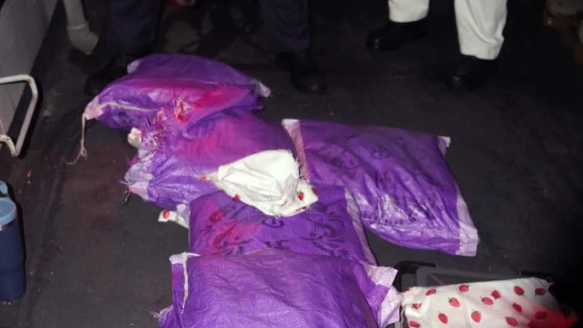Purple packages on the ground which are filled with drugs. 