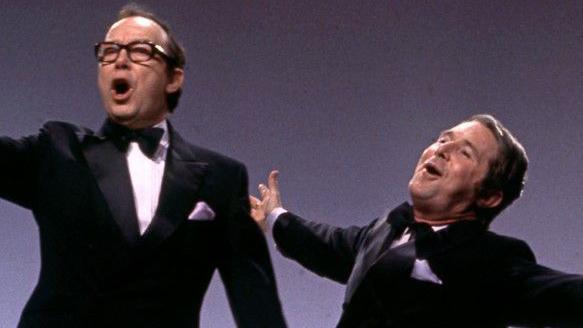 Morecambe and Wise break into song in their bow ties and dinner suits