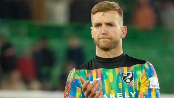 George Long applauds while playing for Norwich City