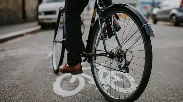 The wheels of a bicycle on the pavement