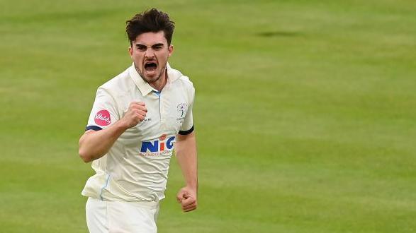 Jordan Thompson punches the air in celebration after taking a wicket for Yorkshire