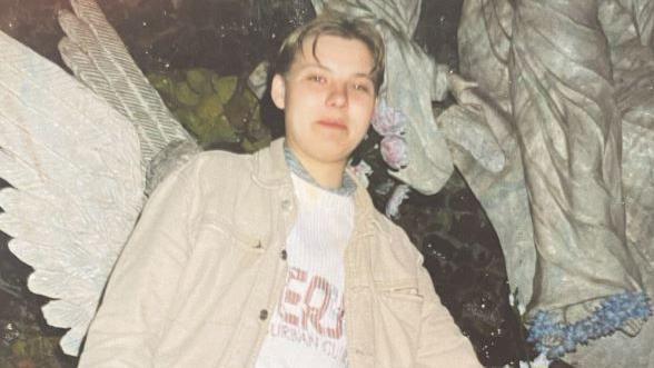 A photograph of Izabela Helena Zablocka wearing a white denim over shirt