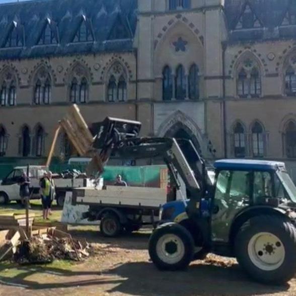 Tractor in process of digging up camp garden