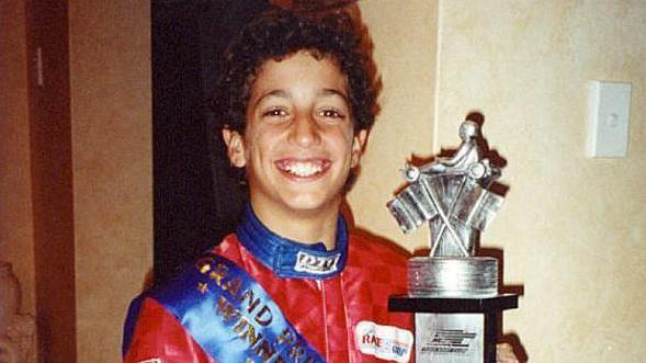 A young Daniel Ricciardo with a go-kart racing trophy