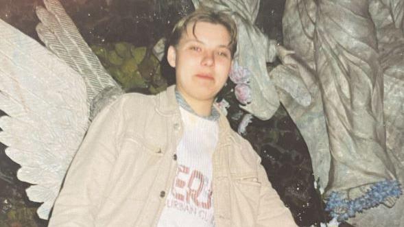 Picture of Izabela. She has short, fair hair and is wearing a beige jacket.