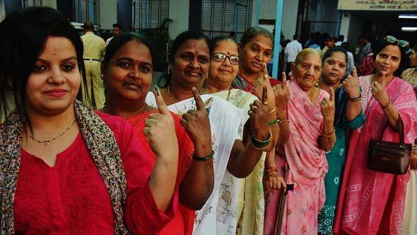 During the Municipal Corporation general elections in Thane at Kisan nager voting centre, women seen showing the ink mark on their fingers after casting their votes, on January 15, 2026 in Mumbai, India.