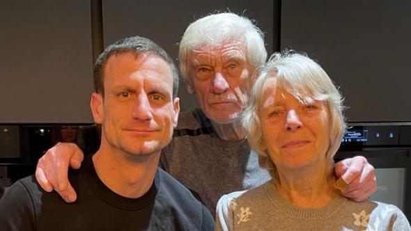 Steve with his Dad Ron and Mum Pat smiling to camera