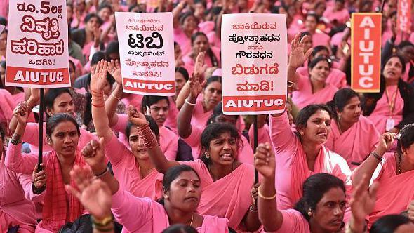 Hundreds of women in pink saris seen holding placards and shouting slogans during an indefinite protest in Bengaluru in Karnataka, India on January 7.