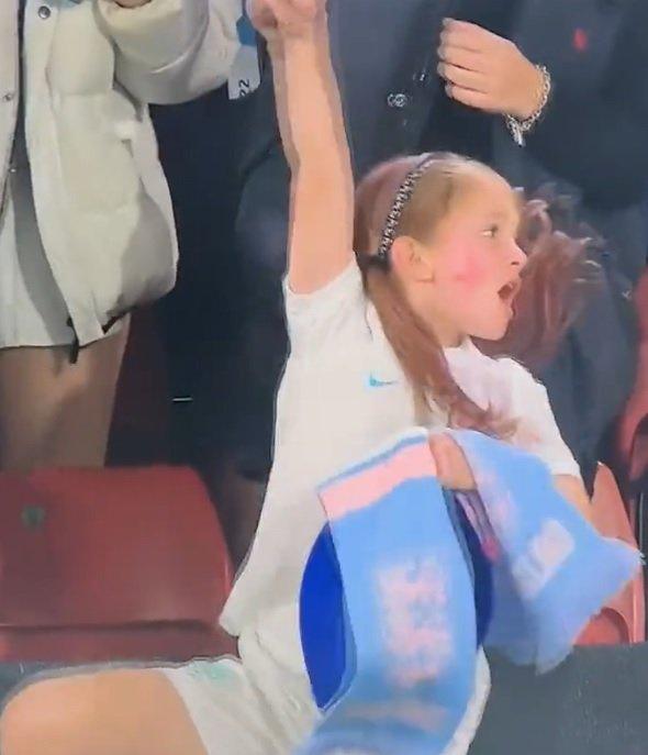 Young girl dances in an England kit.