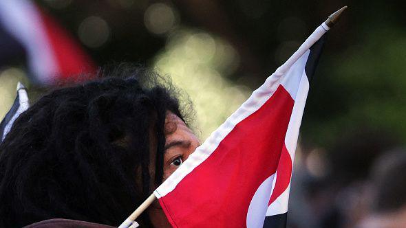 People attend a protest criticising the government for its policies toward the Indigenous Maori population which they say are racist policies and undermine a treaty that protects their Indigenous rights, outside the New Zealand parliament in Wellington on May 30, 2024. 