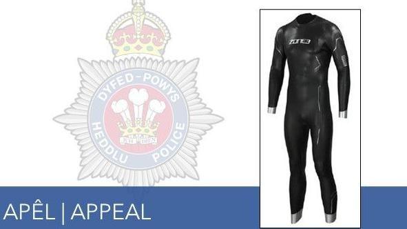 A police photo of the wetsuit in which the body was found in the reservoir. It is a black full body wetsuit with the Zone 3 logo on the chest area.