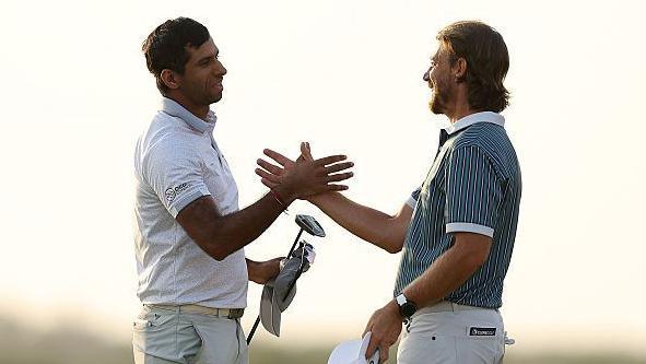 Aaron Rai shaking hands with Tommy Fleetwood after his winning putt.
