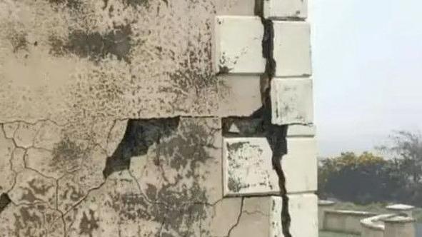 A corner wall of a house which is crumbling because of defective concrete blocks containing high levels of the mineral, mica, which absorbs water, causing walls to crack 