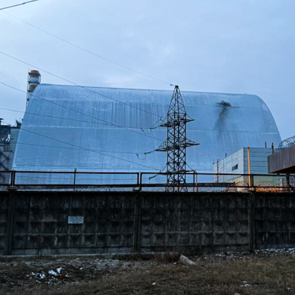 The steel shell protecting Chernobyl's reactor with a dark hole in the top corner