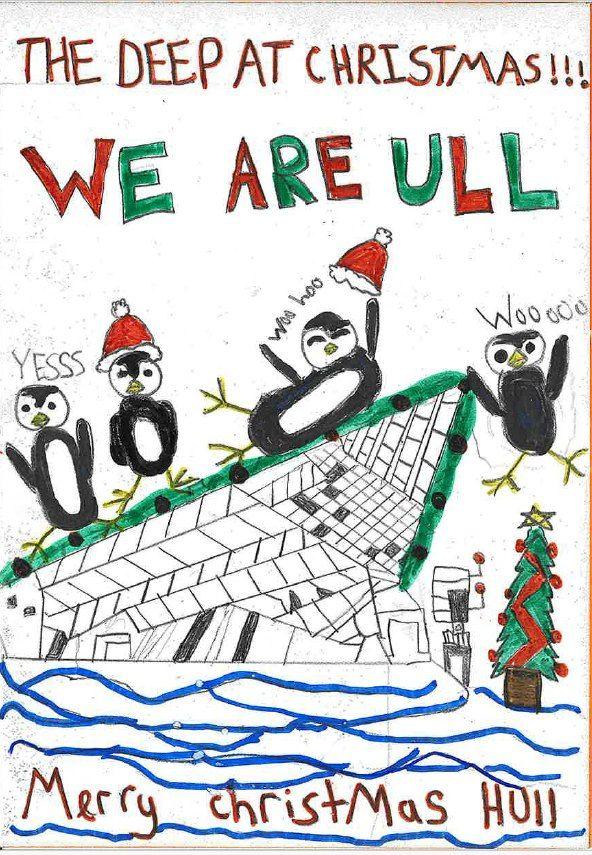 A Christmas card drawn by a primary school child, featuring penguins wearing Santa hats sliding down the aquarium's slanted roof.