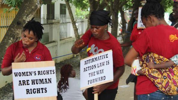 Advocacy group Abantu for development reps holding affirmative action placards