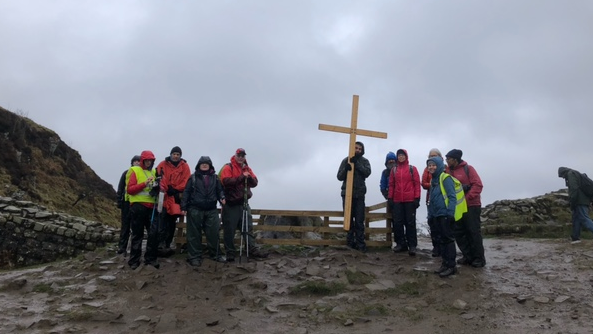 Walkers at the site of Sycamore Gap