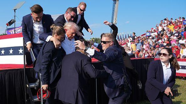 Secret Service escort former President Donald Trump off the stage in Butler, Pennsylvania 