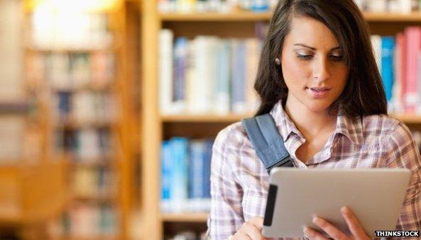 Student reading an iPad