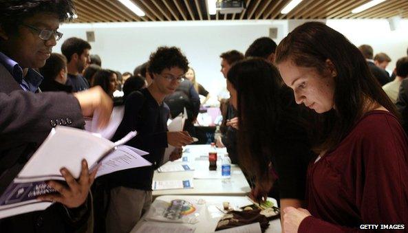 Job seekers speak with company recruiters at the New York City Start-up Job Fair