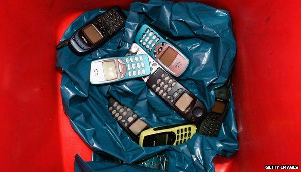 Nokia phones in a bin