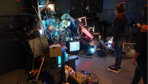 Gigantic tangle of computer parts and girl