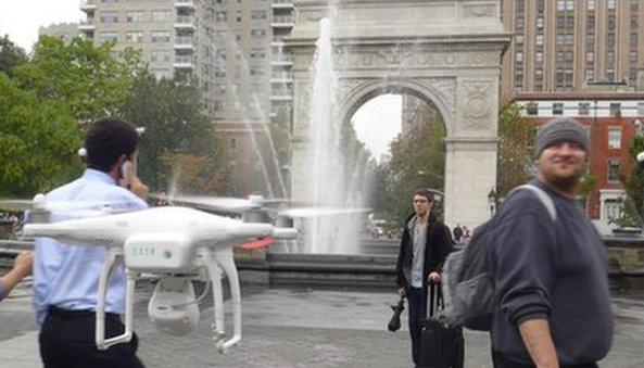 Man drone and Washington square park arch