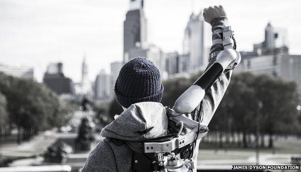 Man wearing Titan Arm raised aloft