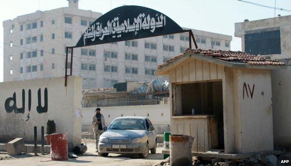 Rebels outside the children's hospital in Aleppo's Qadi Askar district that had become headquarters of the Islamic State in Iraq and the Levant (ISIS) (8 January 2014)