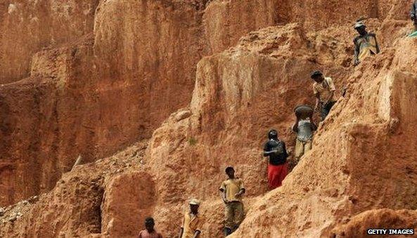 Workers up a mountain in the DR Congo