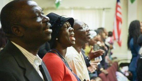 Churchgoers sing during a service in Massachusetts