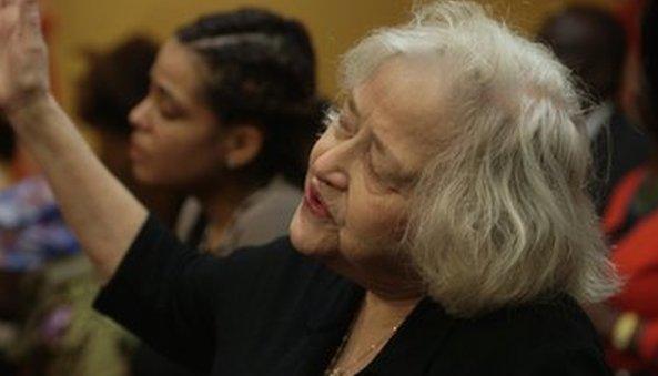 A woman sings during a church service in Massachusetts