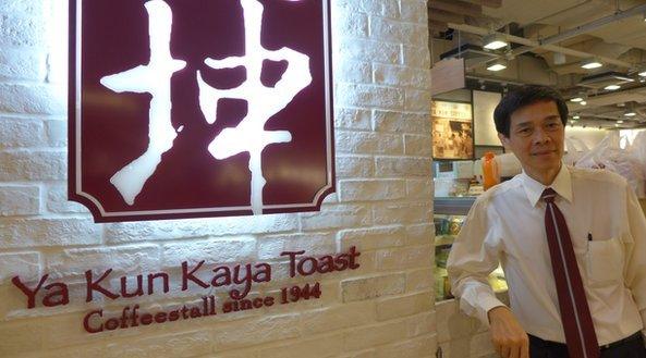 Adrin Loi in front of Ya Kun sign