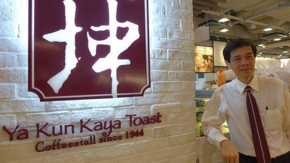 Adrin Loi in front of Ya Kun sign