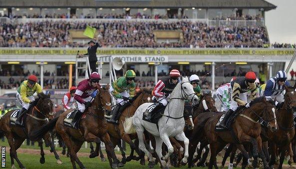 Horses and riders get under way as the starter (background) waves his flag for a false start