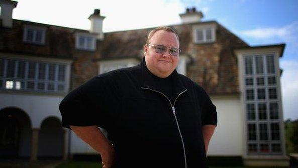 Kim Dotcom outside his mansion