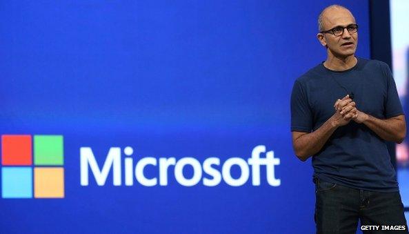 Satya Nadella and Microsoft logo