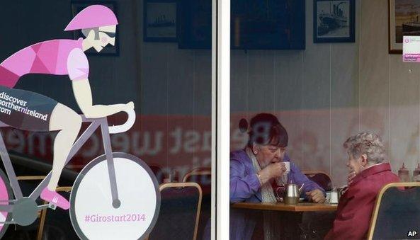 Women sit in an east Belfast café advertising the Giro d'Italia