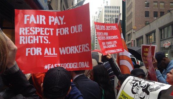 Fair Pay respect for our rights sign and protestors