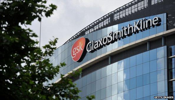 GSK building with logo and tree in front