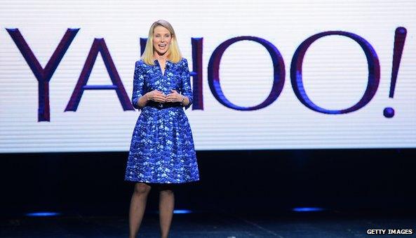 Marissa Mayer in front of yahoo logo