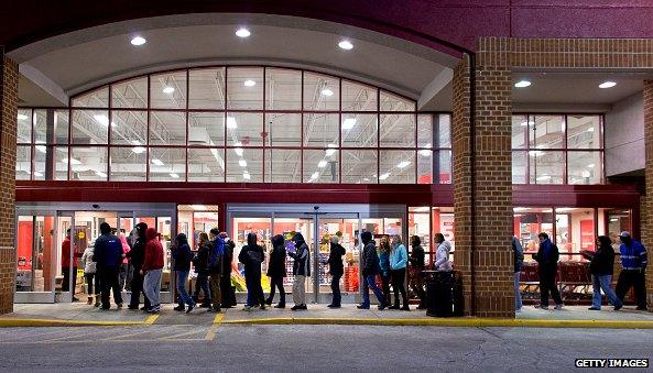 Shoppers at night outside home depot