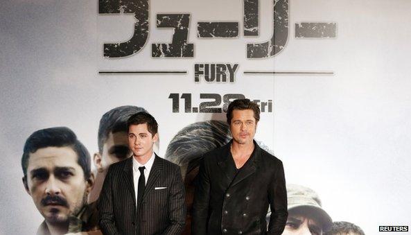 Cast members Brad Pitt (R) and Logan Lerman pose for pictures on the red carpet for the Japan premiere of the movie "Fury" in Tokyo