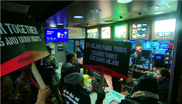 Workers in McDonalds with protest signs