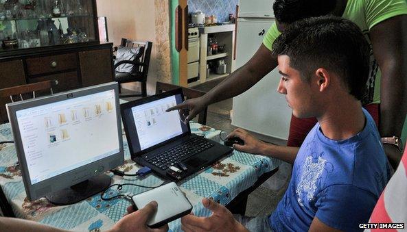 Young Cubans prepare their sticks and portable hardisks to charge the latest internet 'package' with films, television series, software and other similar stuff from foreign origin downloaded from the web