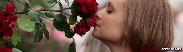 woman smelling roses